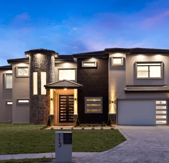 A modern two-story home at dusk built by Caza Group in the Rio Grande Valley