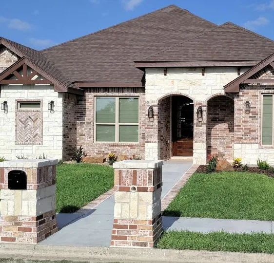 A brick and stone new home on Los Fresnos Ave built by Divine Custom Homes